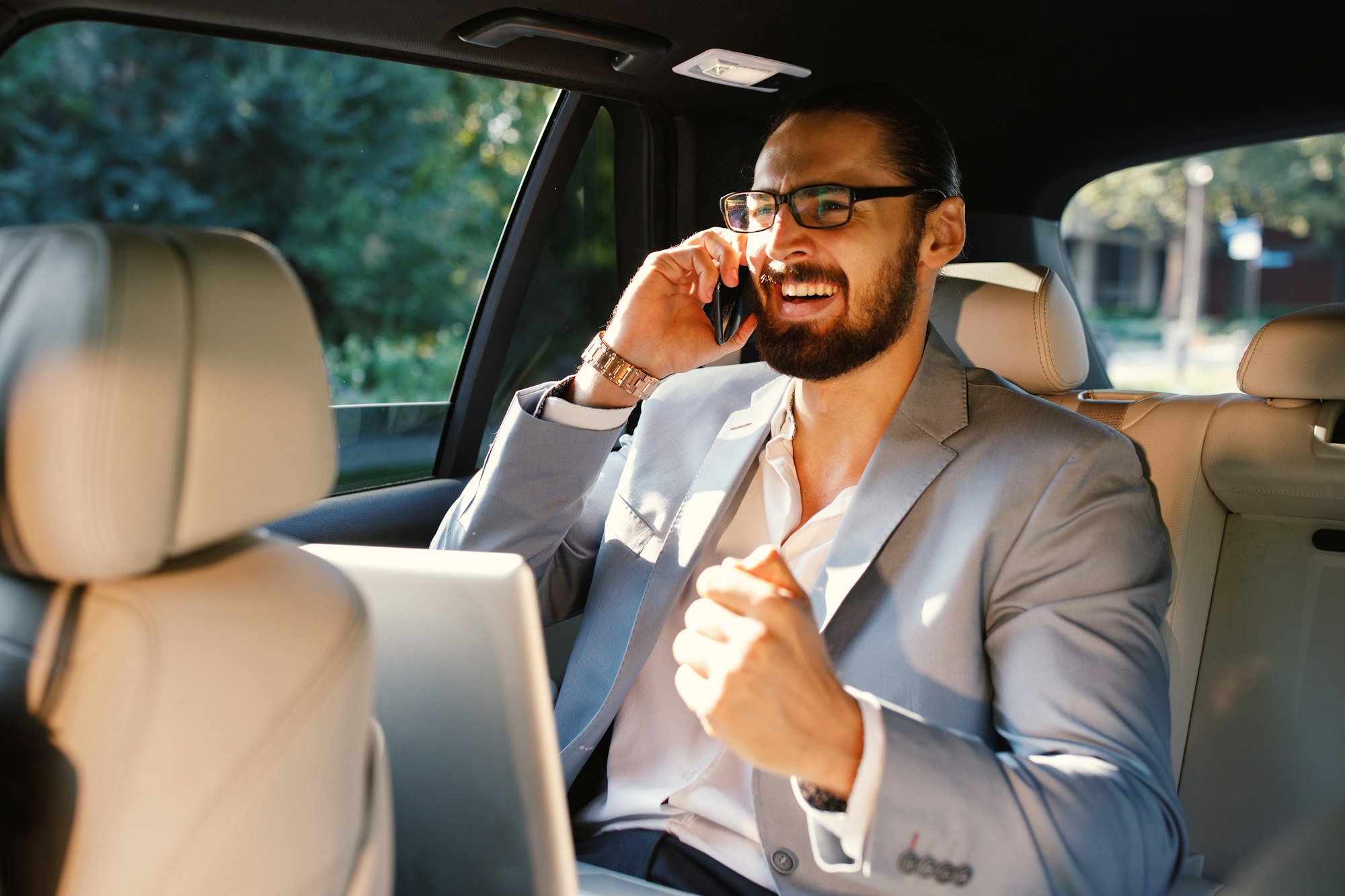 Businessman talking on the phone in a taxi